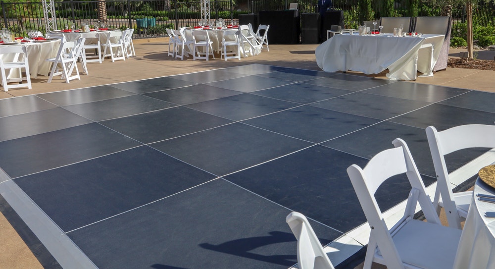 Portable dance floors are super easy to put together and take back down, and work inside and outside on any hard, flat surface.